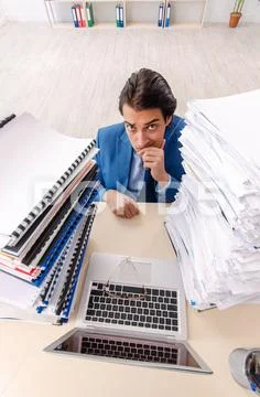 Young handsome businessman unhappy with excessive work Stock Photos