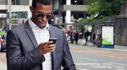 Young handsome businessman using cell phone or smartphone in the city Stock-Footage 57094747