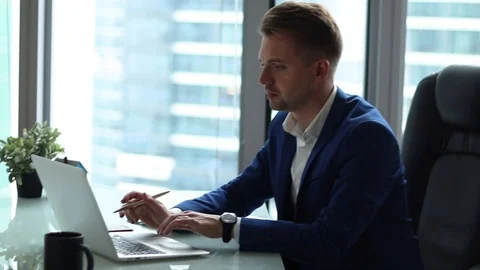 Young handsome businessman working at the computer in his office. Stock Footage 97046214