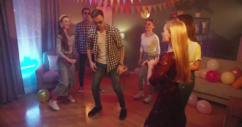 Young handsome Caucasian guy dancing in the rhythm of the music and moving funny Stock Footage 122505272