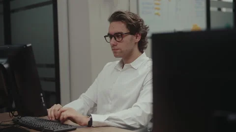 Young handsome caucasian male programmer typing on keyboard, concentrated on 動画素材 342933191