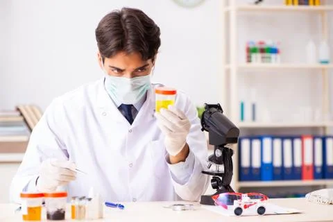 Young handsome chemist working in the lab Fotos Stock