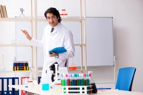 Young handsome chemist working in the lab Stock Photos