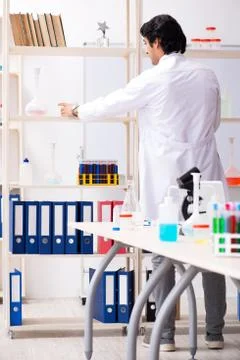 Young handsome chemist working in the lab Stock Photos