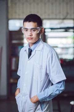 Young handsome chemist working in the lab Stock Photos