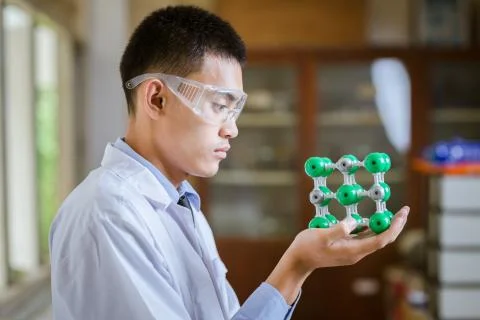 Young handsome chemist working in the lab Stock Photos