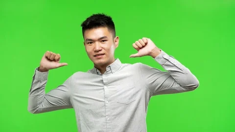 Young handsome chinese man pointing fingers, example to follow Stock Footage