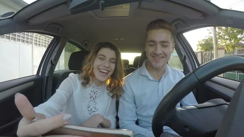 Young handsome couple having conversation trough video call in the car on sma Stock Footage 85598225