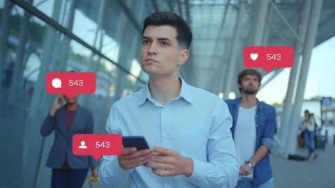 Young handsome dark haired man in blue shirt holding smartphone in hands walking Stock Footage 142337203