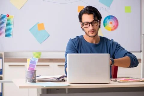Young handsome designer working at the project Stock Photos