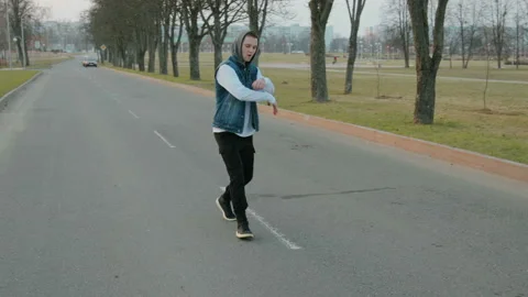 A young, handsome, energetic guy in black trousers and a blue hooded vest Stock Footage 108509615