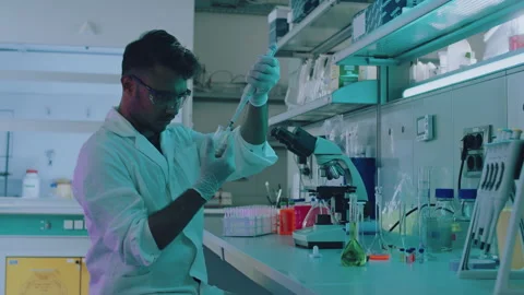 Young Handsome Ethnic Lab Worker Taking a Sample out of a Test Tube Stock Footage 164995674