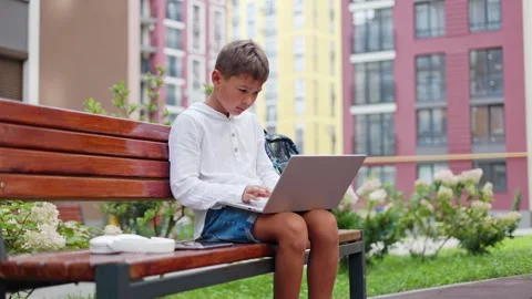 Young Handsome Guy After School Typing on Laptop while Sitting Outside. Stock Footage 249353896