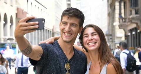 Young handsome guy and a girl in a hat, having fun, smiling happily Stock Footage