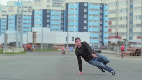Young handsome guy dancing hip hop outdoors in the city. Slow motion Stock Footage 138808631