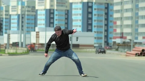 Young handsome guy dancing hip hop outdoors in the city. Slow motion Stock Footage 138808753