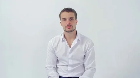 Young handsome guy at a job interview covers mouth with hand from shock Video stock 83597536