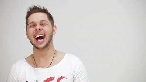 Young, handsome guy laughing at the camera Stock Footage 22219399