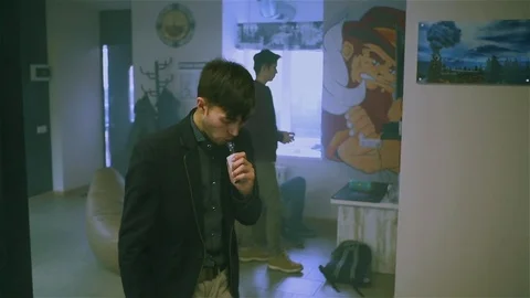 Young handsome guy lets rings out of steam Stock Footage 73027647