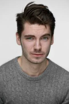 Young handsome guy looking in camera in fornt of white background Foto stock