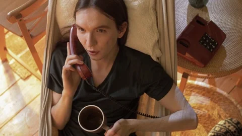 Young handsome guy is romantically chatting through a telephone receiver Stock-Footage 245992061