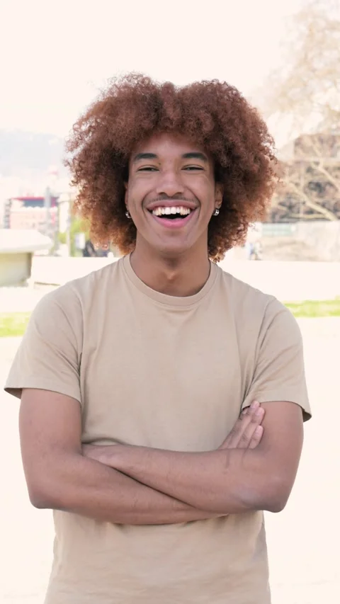 Young handsome guy smiling relaxed and looking at camera in the street with arms Stock Footage 247771441