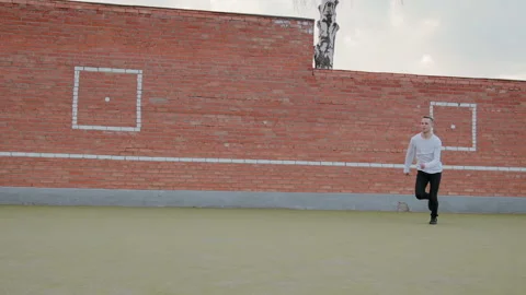 Young handsome guy, a street dancer performing a leap of Grand jete on the Vídeo Stock 108722223