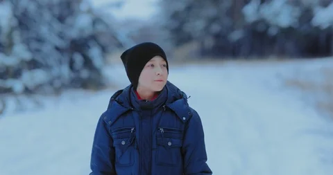Young handsome guy is walking on a winter road, he is happy. Frosty day, winter Stock Footage 123181628