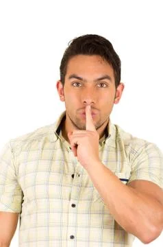 Young handsome hispanic man gesturing a secret Stock Photos