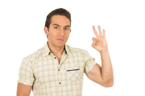 Young handsome hispanic man posing gesturing all right Stock Photos