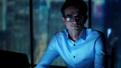 Young Handsome IT Manager Sitting in the Office with Laptop Looking at the Stock Footage 93279998