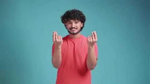 Young handsome latin hispanic man with beard on blue studio background doing Stock Footage 239359722