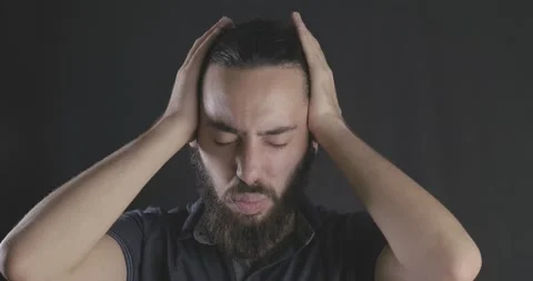 Young handsome long haired man's headache. Guy is touching her head, migraine Stock Footage 139826412