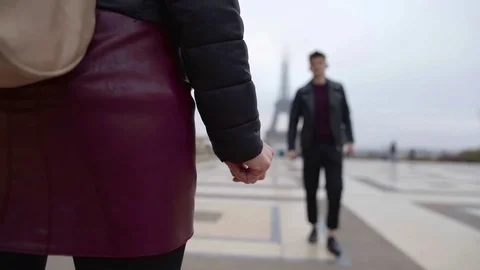 Young handsome man is approaching to his brunette girlfriend and they are Stock Footage 98808852