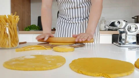 Young handsome man in apron kneading dough in modern kitchen. Concept of Stock Footage 171426028