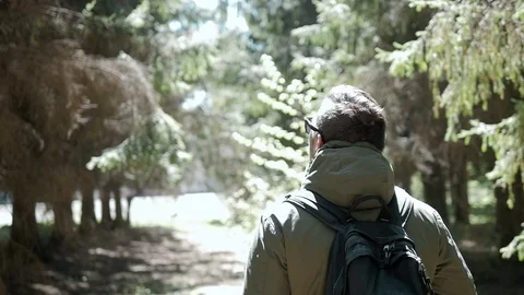 Young handsome man backpacker hker tourist traveler with a marching backpack Stock Footage 76141196