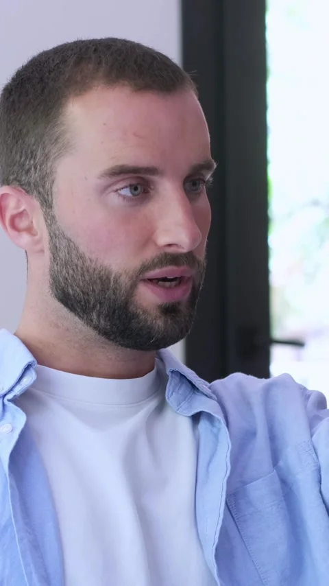 Young handsome man with a beard actively talking and using hand gestures Stock Footage 345114342