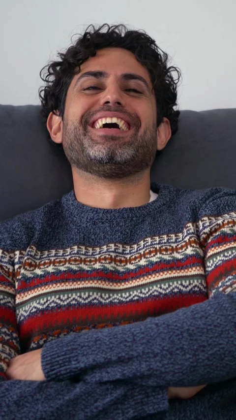 Young handsome man with beard wearing winter sweater with happy face smiling Stock Footage 313447476