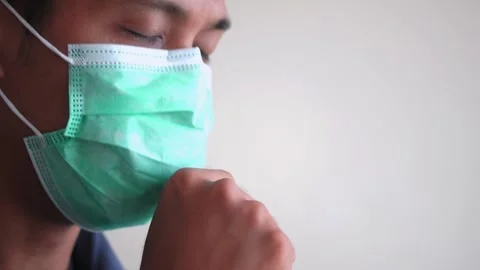 Young handsome man with beard wearing medical mask Stock Footage 328646396