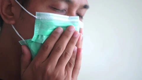 Young handsome man with beard wearing medical mask Stock Footage 328646419