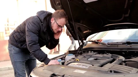 Young, handsome man in black jacket and glasses standing behind his car (4) Stock-Footage 49338018