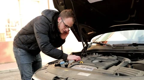 Young, handsome man in black jacket and glasses standing behind his car (4) Stock Footage 49338032