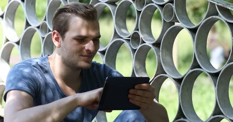 Young Handsome Man Browsing Digital Tablet Cute Boy Send Message to Girlfriend Stock Footage 81496300