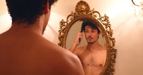 Young handsome man brushing his hair confident sucessfull Stock Footage 120215510