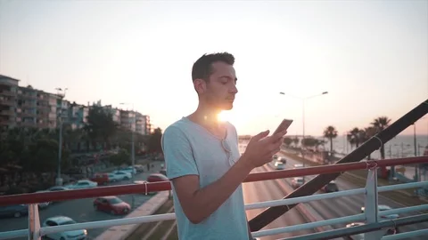 Young handsome man is calling with mobile phone and speaking.  Stock Footage 112895236