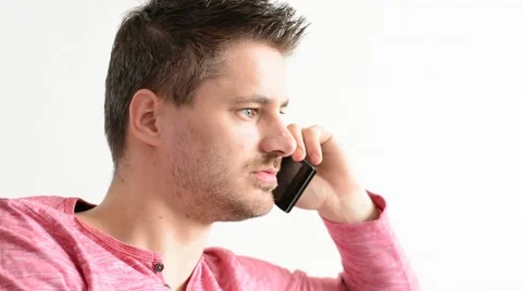 Young handsome man calling with smart phone in his flat wearing red t-shirt. Stock Footage 53746938