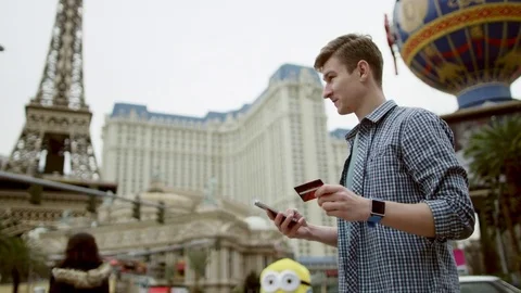 Young handsome man is calling someone over his cellphone Stock Footage 77317867
