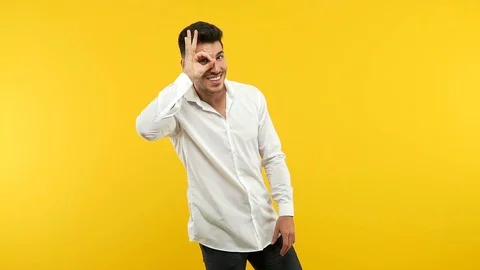 Young handsome man confident doing ok gesture on eye Stock Footage 97657805