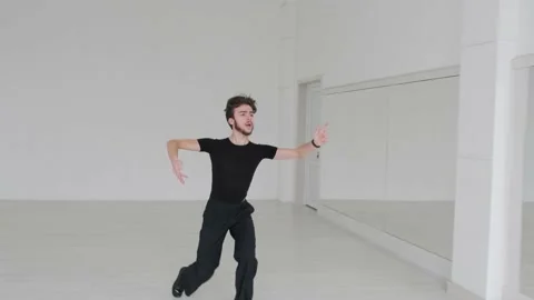 Young handsome man dancing ballroom dancing. A professional ballroom dancer trai Stock Footage 144336645