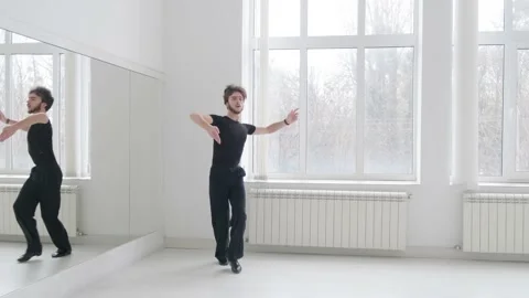 Young handsome man dancing ballroom dancing. A professional ballroom dancer trai Stock Footage 144603708